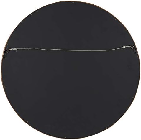 Round walnut wall mirror in entryway setting
