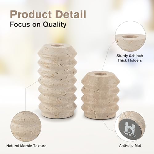 Travertine candle holders with lit taper candles