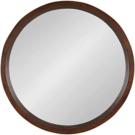 Round walnut wall mirror close up of wood frame