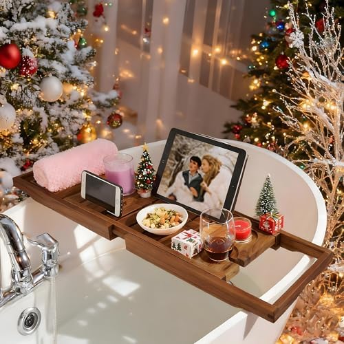 Teak bathtub caddy styled in a modern bathroom with candles and greenery