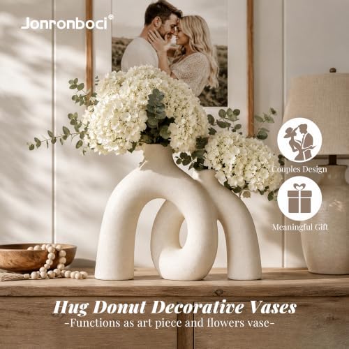 Ceramic donut vase styled on a console table
