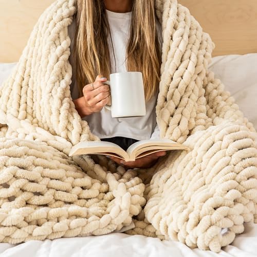 Chunky knit throw blanket draped over person reading