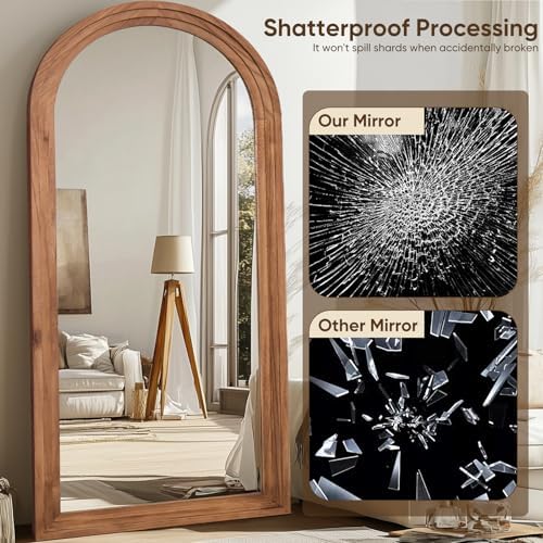 Arched wood floor mirror in an entryway