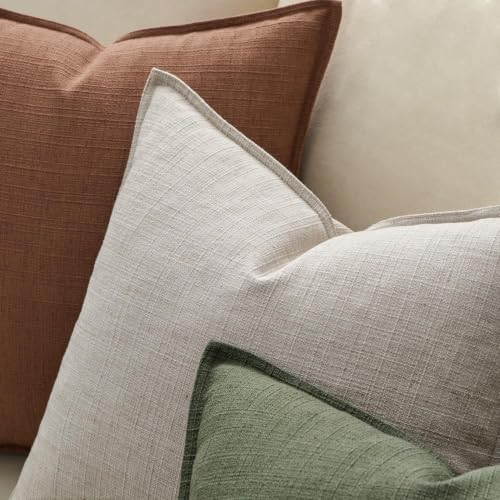 Linen throw pillow covers on a bed