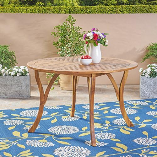 Acacia wood outdoor dining table styled on a patio