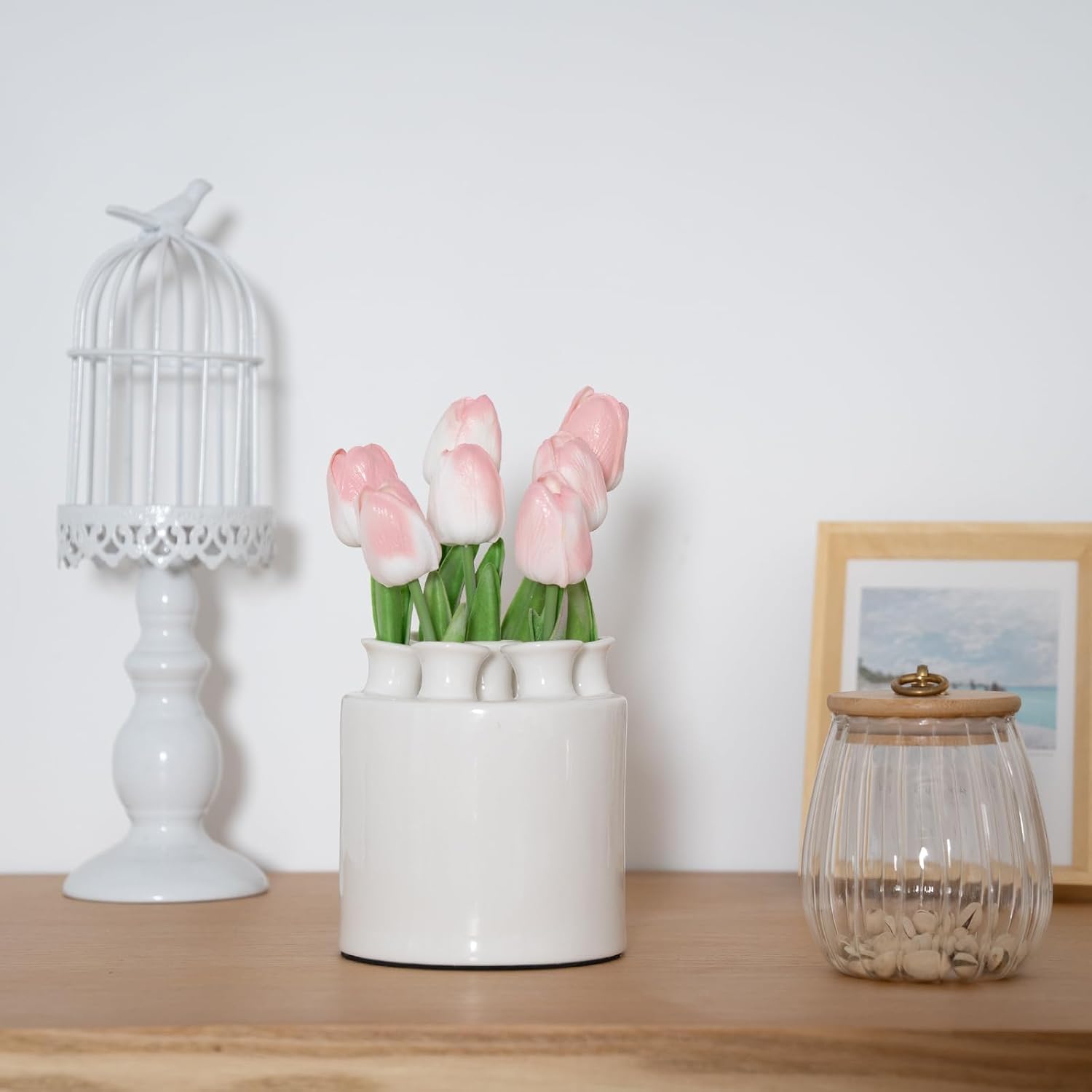 Modern white ceramic tulip vase with seven openings on a plain background