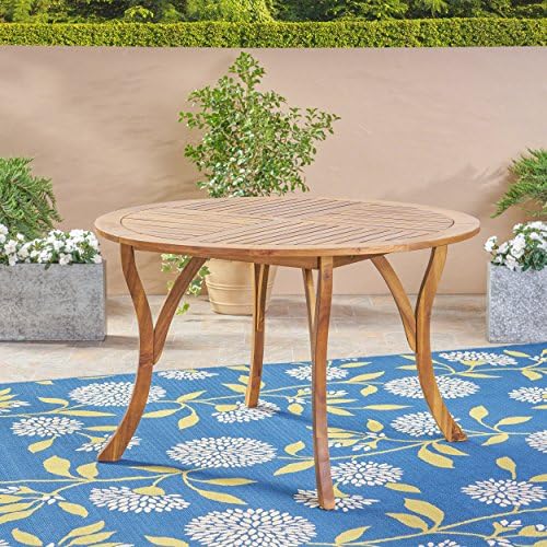 Outdoor dining table with chairs around it
