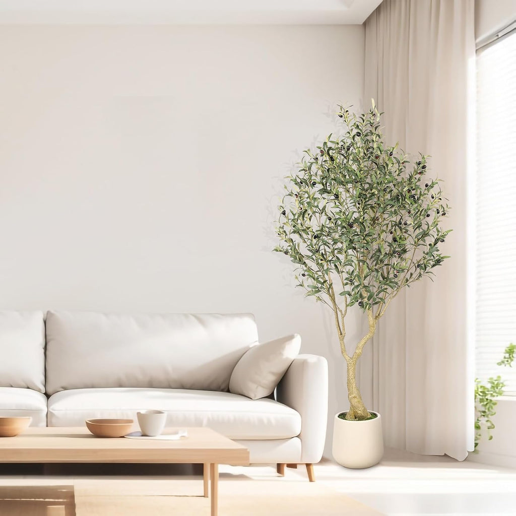 6 ft faux olive tree beside a neutral sofa in a bright living room