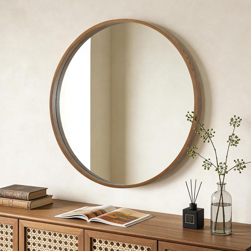 Round wood mirror above a console with rattan doors