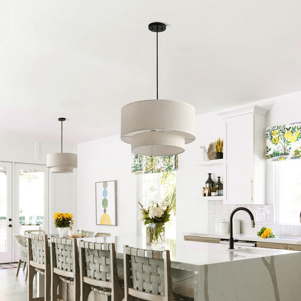 Linen drum pendants hanging over a kitchen island