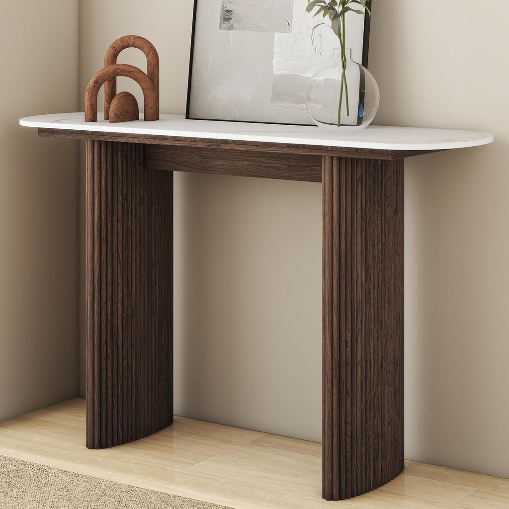 Modern fluted console table with sintered stone top on a plain background