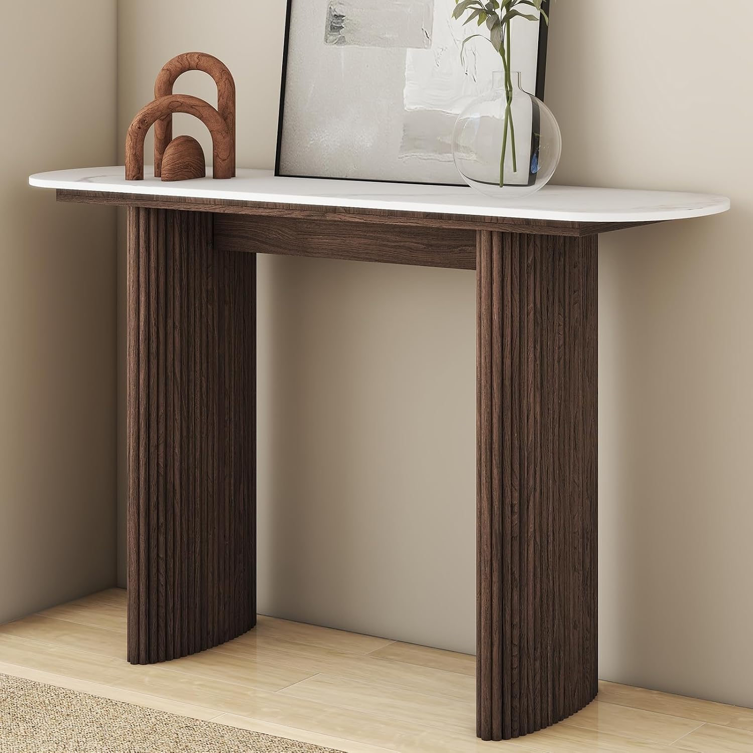 Modern fluted console table with sintered stone top on a plain background