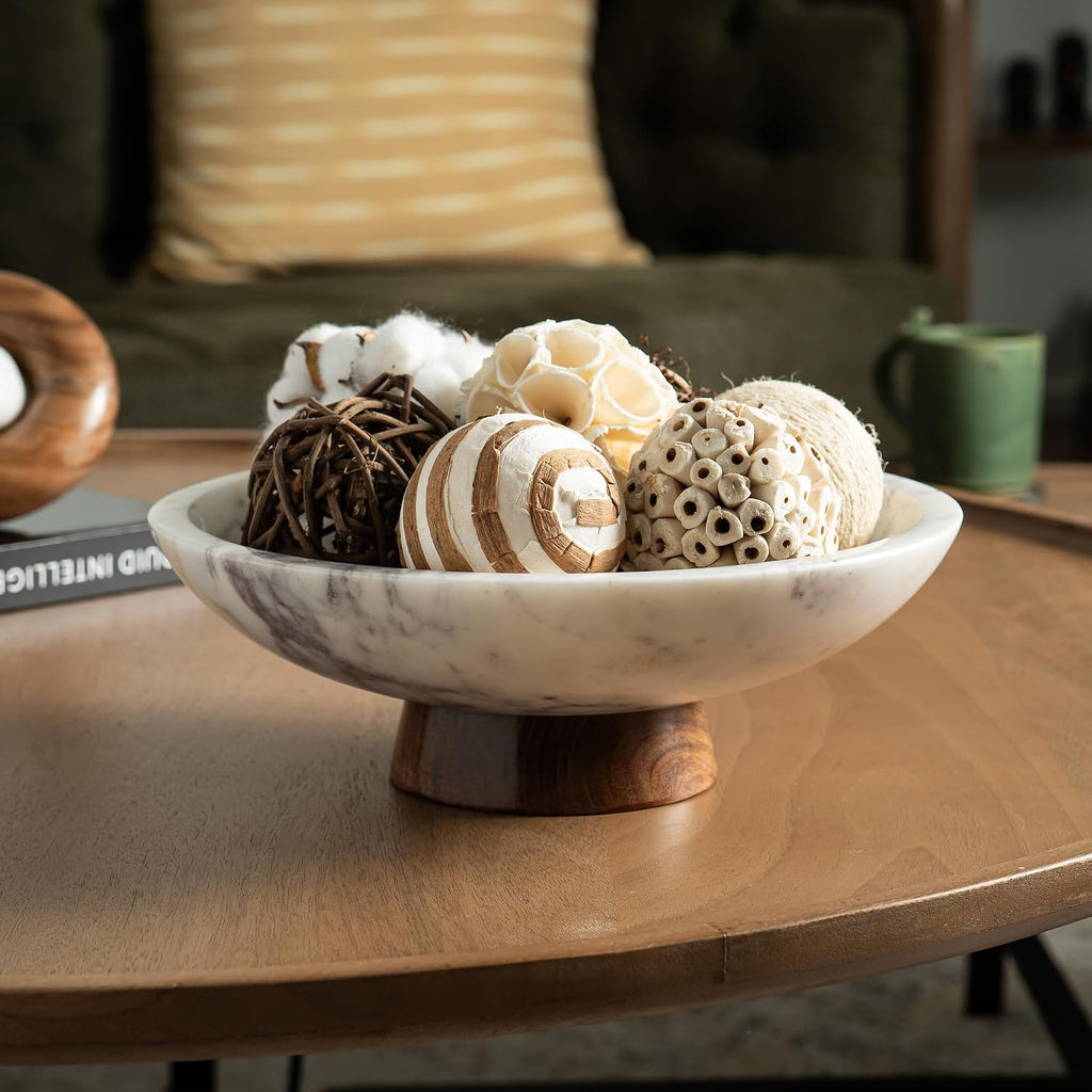 White marble pedestal bowl with acacia base on a wood dining table