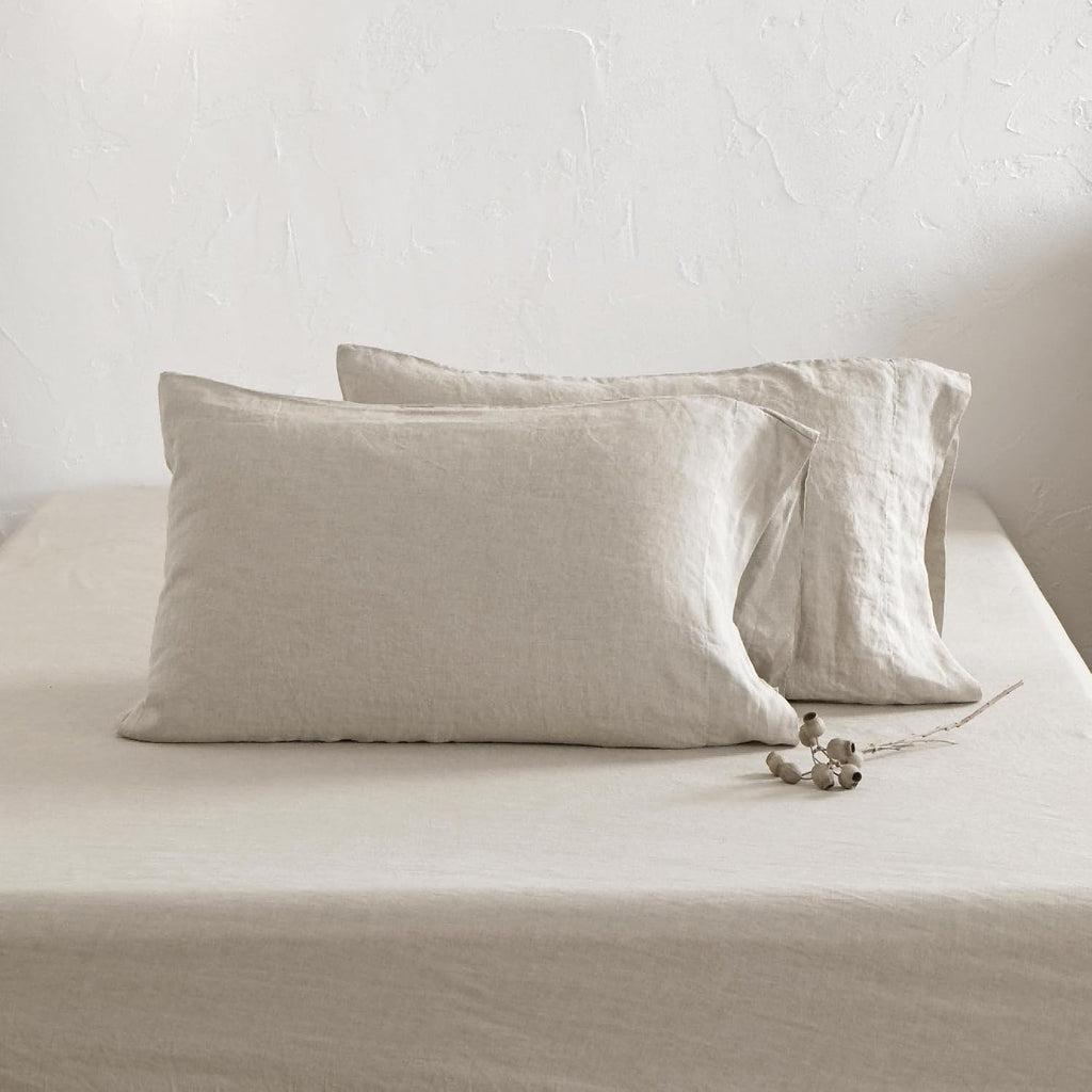 Close-up of natural linen pillowcases and fitted sheet