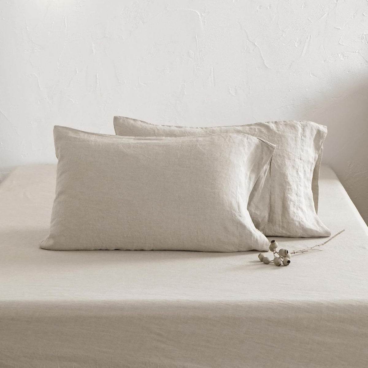 Close-up of natural linen pillowcases and fitted sheet