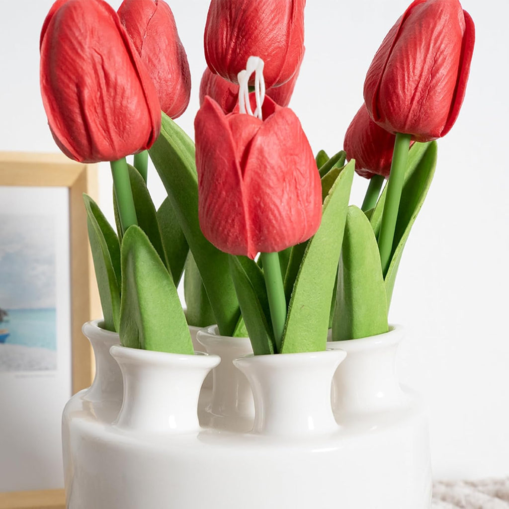Tulip ceramic vase styled with a book and throw blanket
