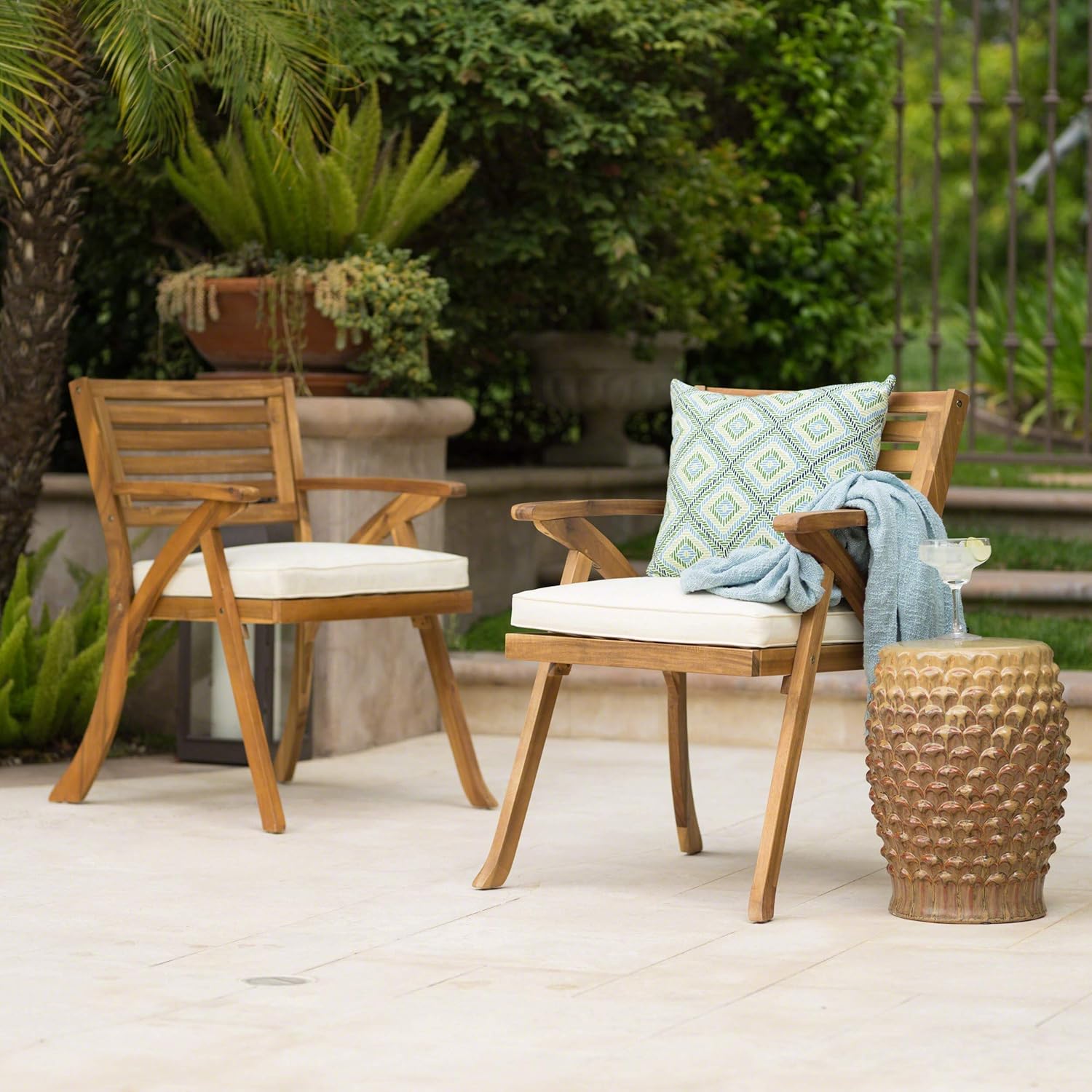 Hermosa acacia patio arm chairs styled on an outdoor patio