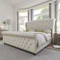 Tufted upholstered sleigh bed styled in a bedroom