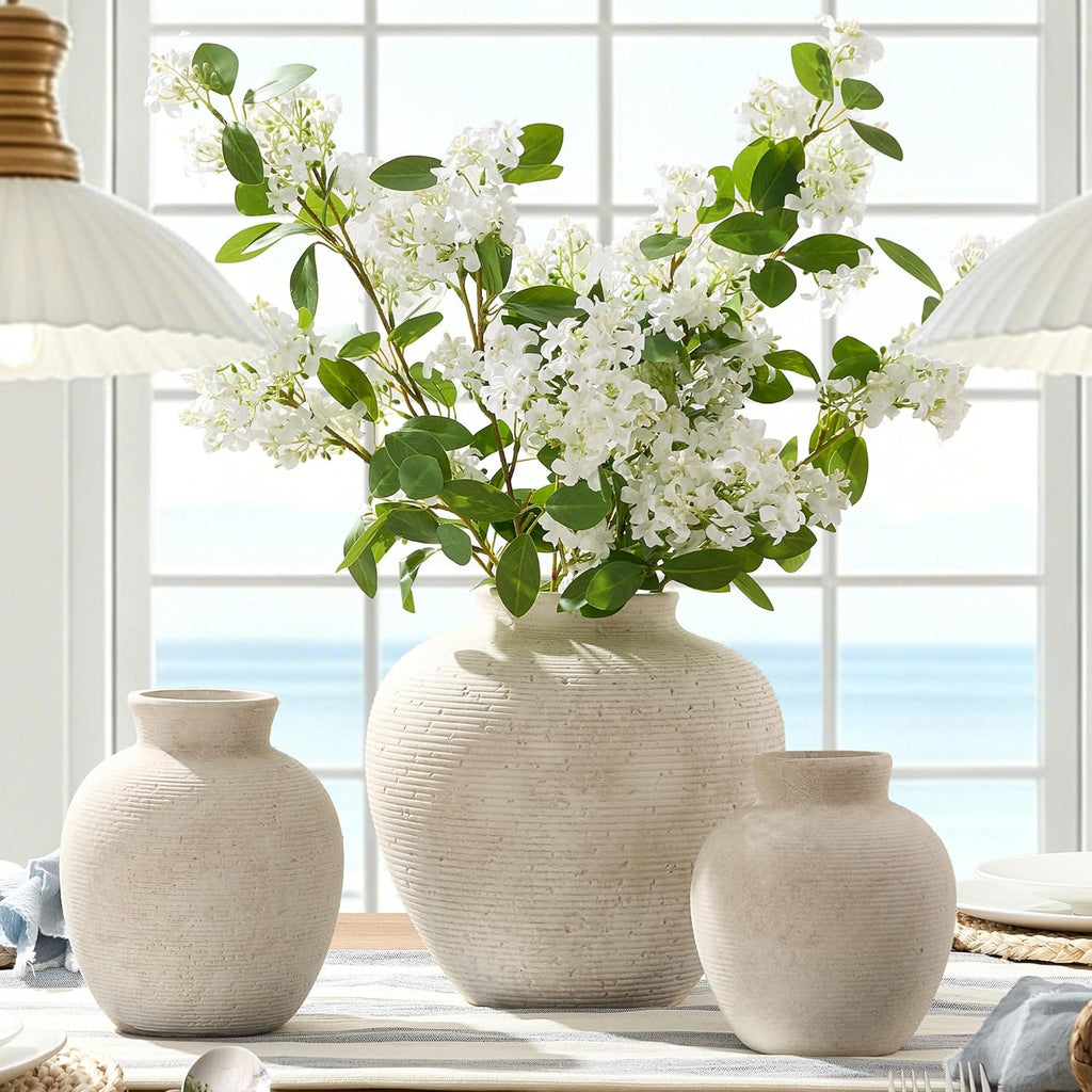 Textured white ceramic vases styled with white flowers