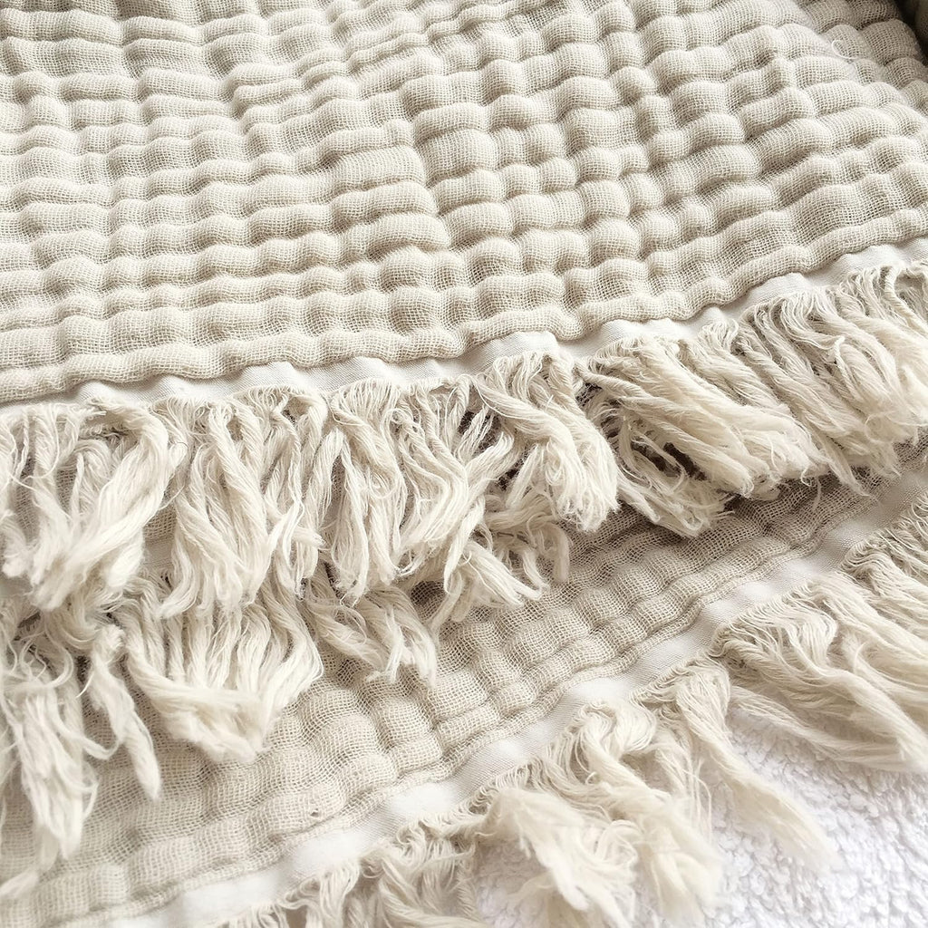 Close-up of crinkled cotton gauze texture and frayed fringe