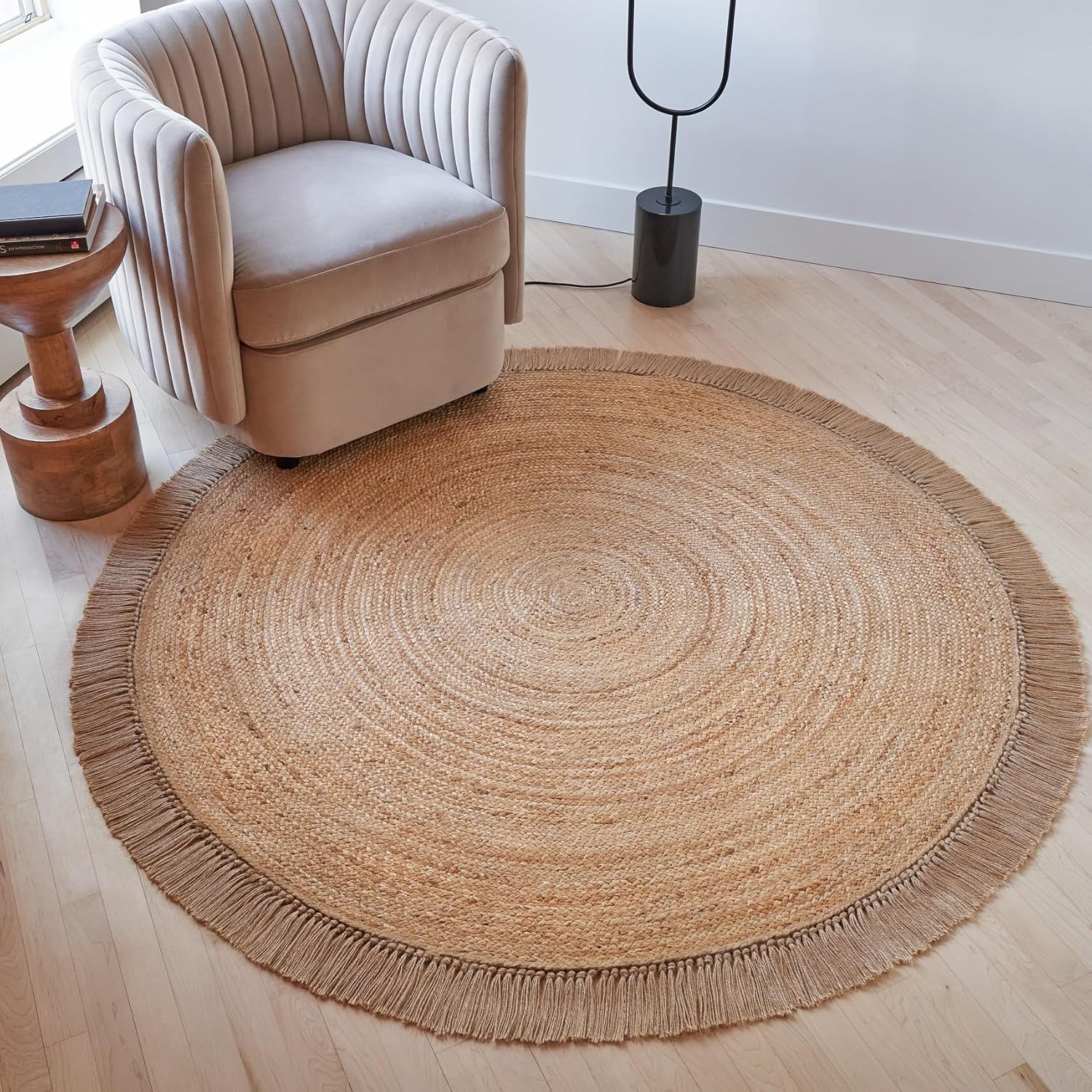 Round woven jute area rug styled in entryway
